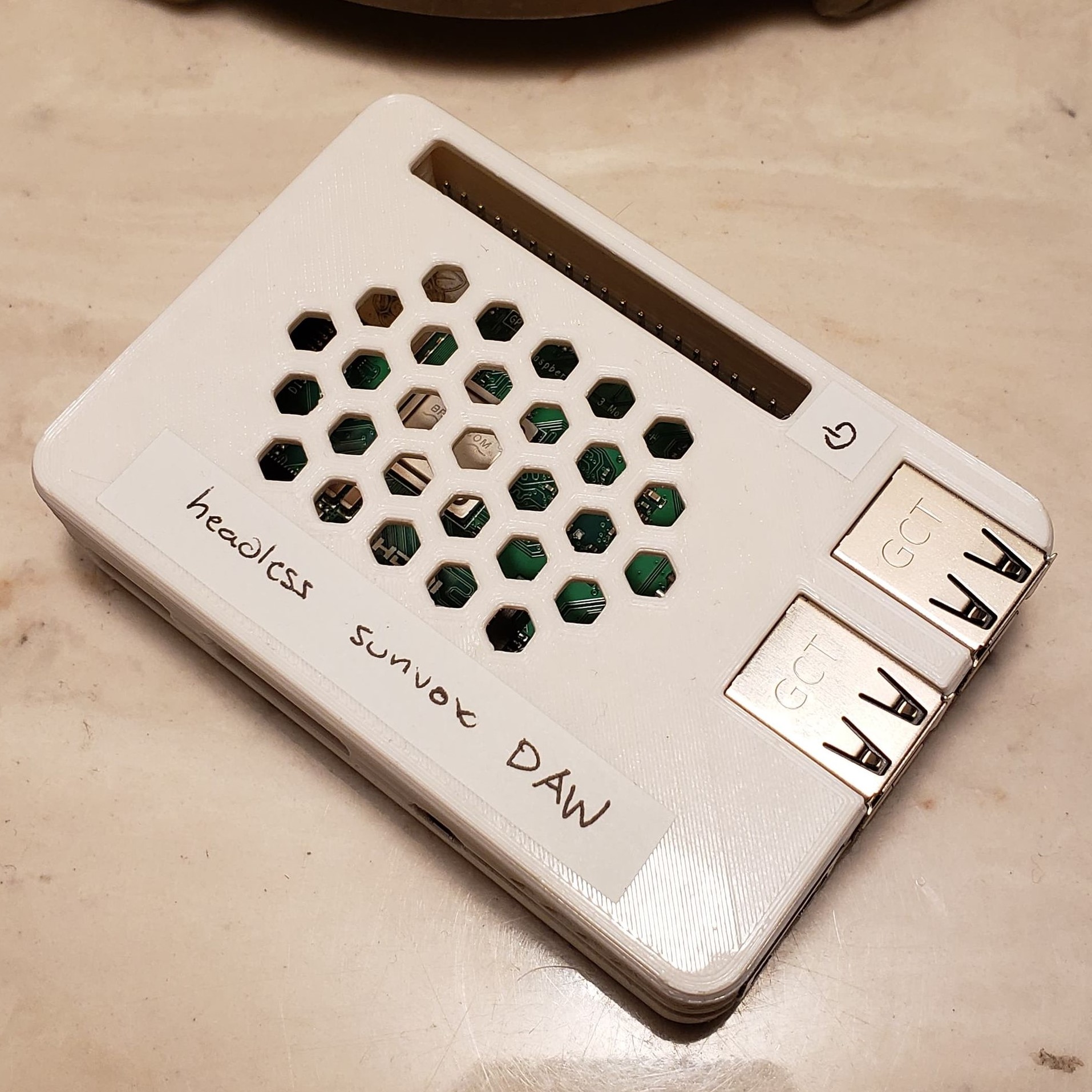 Orthographic view of a Raspberry Pi in a white 3D-printed case, labelled "headless sunvox DAW"