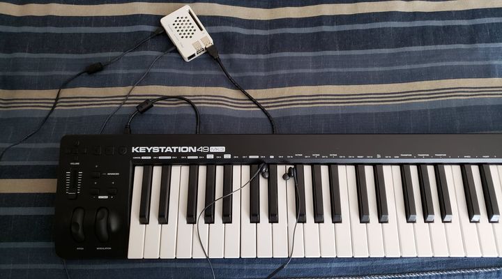 Raspberry Pi in its case, wired to an M-AUDIO Keystation 49